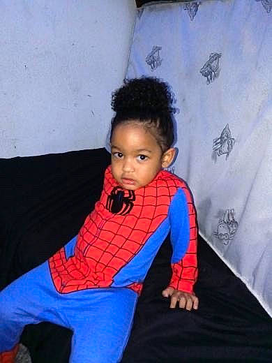 Kendrick is registered to the contest to win money with this photo: baby_toddler_clothing, chair, child, comfort, electric_blue, eye, flooring, fun, hair, head, human_body, linens, magenta, orange, pattern, person, room, sleeve, t_shirt, textile