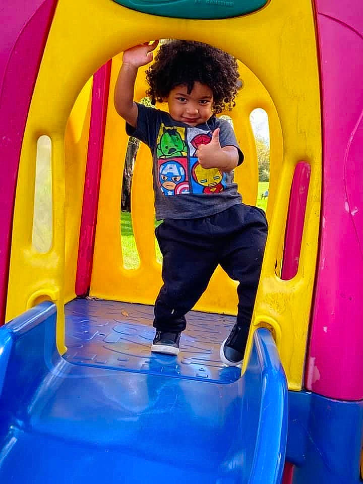 Kendrick joined the competition — help win amazing prizes! baby_toddler_clothing, blue, child, chute, city, electric_blue, fun, green, leisure, outdoor_play_equipment, person, photograph, playground, recreation, shorts, smile, snapshot, t_shirt, toddler, white