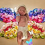 newborn, baby, diaper, hat, flowers, floral_arrangement, butterflies, colorful, background, infant, cute, decorative, fairy_tale, portrait, child, soft_lighting, artistic, whimsical, skin, pose