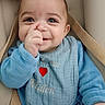 baby, bib, blue_clothing, blue_eyes, car_seat, child, closeup, cozy, cute, expression, face, hand, happy, indoor, infant, nose_picking, portrait, seatbelt, smile, soft_light