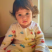 Octavio joined the competition — help win amazing prizes! toddler, child, pajamas, toy, indoors, window, curly_hair, sitting, playtime, colorful, face, expression, cute, person, young_child, floor, bright_colors, casual_clothing, closeup, home