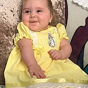 Iyla-Mae joined the competition — help win amazing prizes! baby, clothing, costume, couch, cushion, dress, face, footwear, furniture, hat, head, homedecor, indoors, newborn, person, photography, portrait, sandal, shoe, sitting