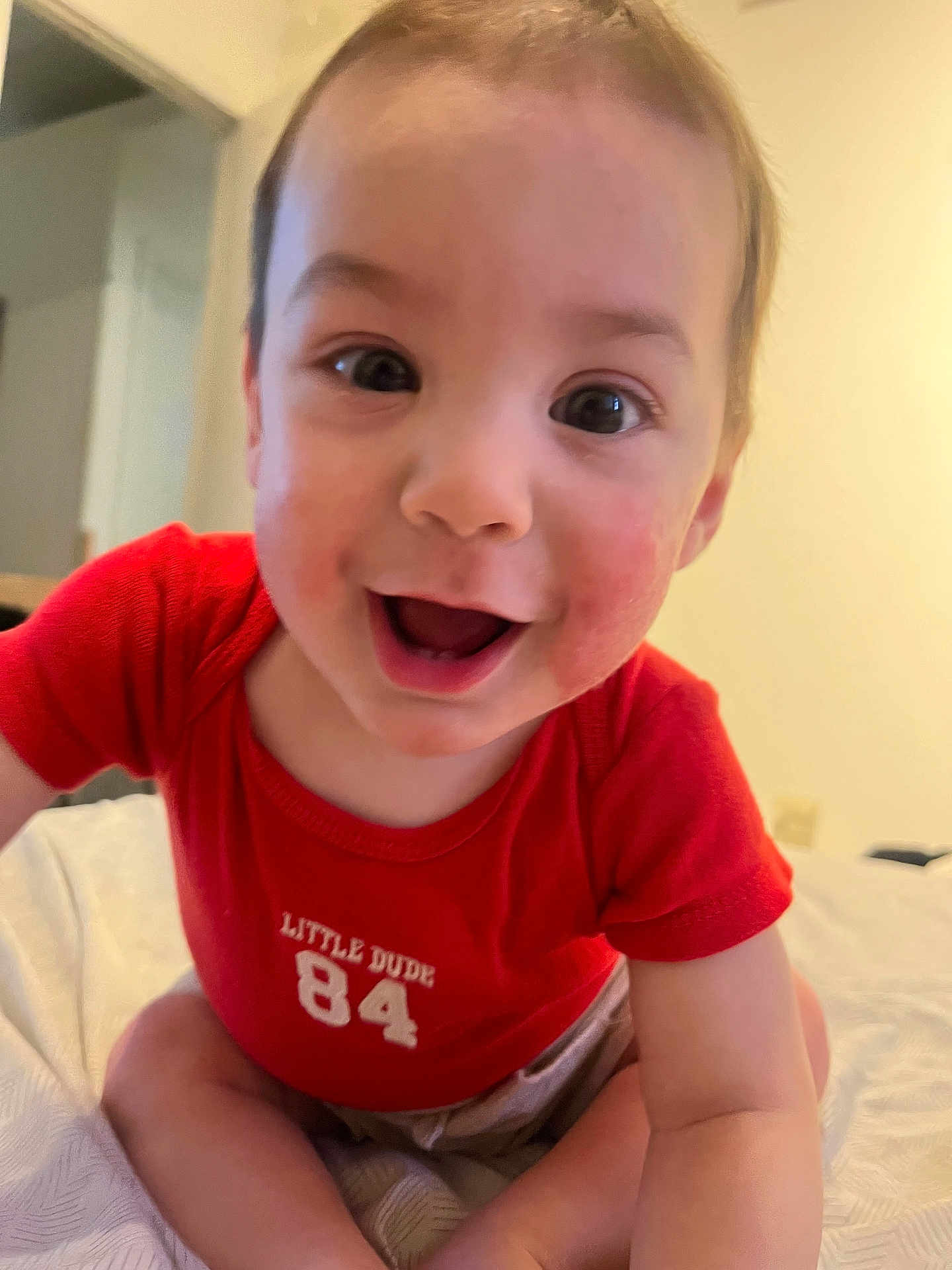 Elieys is registered to the contest to win money with this photo: baby, child, smiling, red_shirt, crawling, indoor, cute, happy, face, person, infant, toddler, clothing, expression, skin, young, sitting, closeup, joy, playful