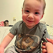 Elieys joined the competition — help win amazing prizes! toddler, child, smiling, shirt, transformers, bed, indoor, person, shorts, hand, holding, cute, happy, face, sitting, young_child, rosy_cheeks, casual_clothing, portrait, home