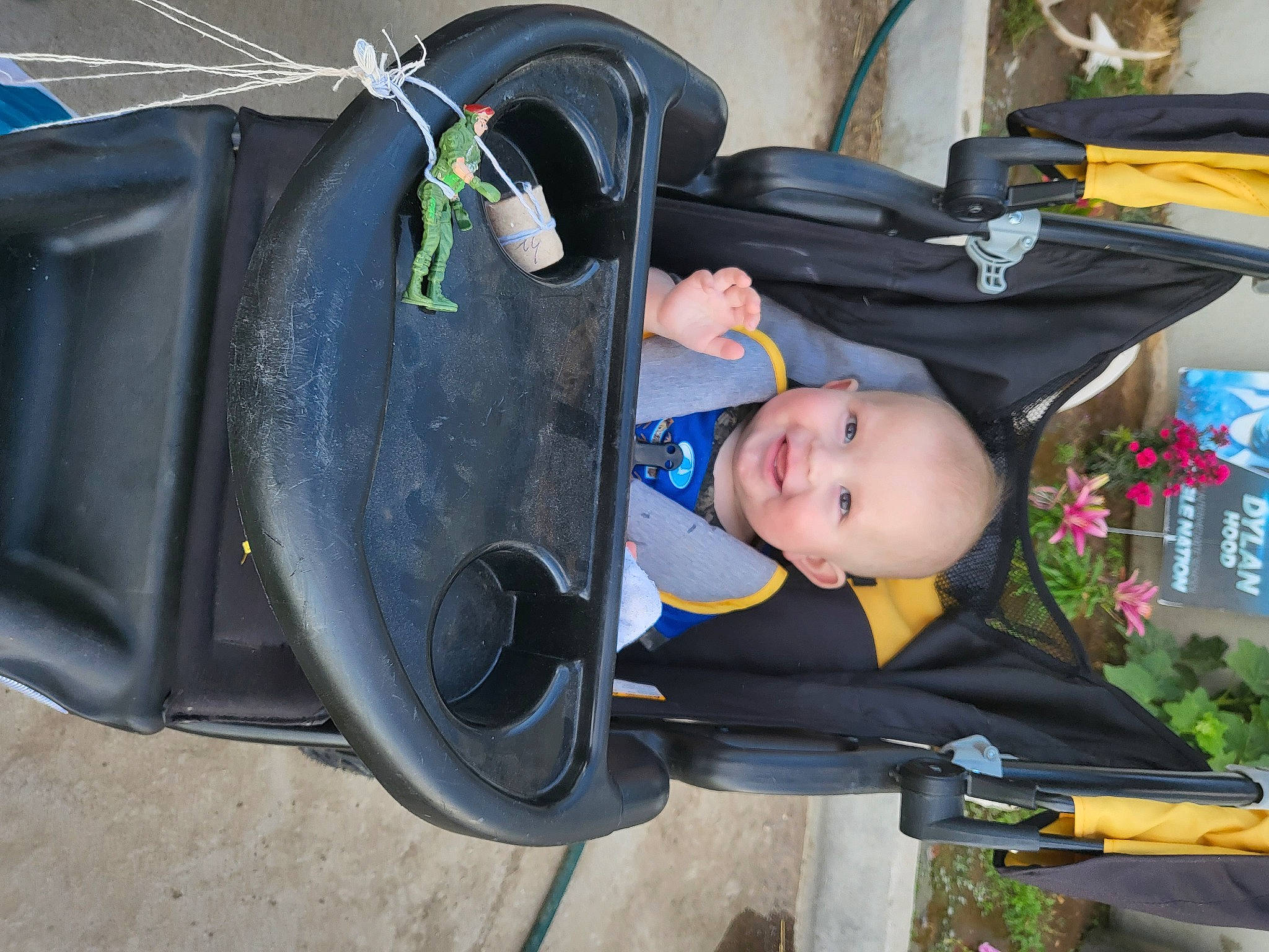 Ryder is registered to the contest to win money with this photo: auto_part, automotive_exterior, automotive_lighting, automotive_tire, baby, baby_carriage, baby_products, baby_safety, baby_toddler_clothing, bumper, child, electric_blue, fender, fun, joy, motor_vehicle, person, personal_protective_equipment, plant, smile