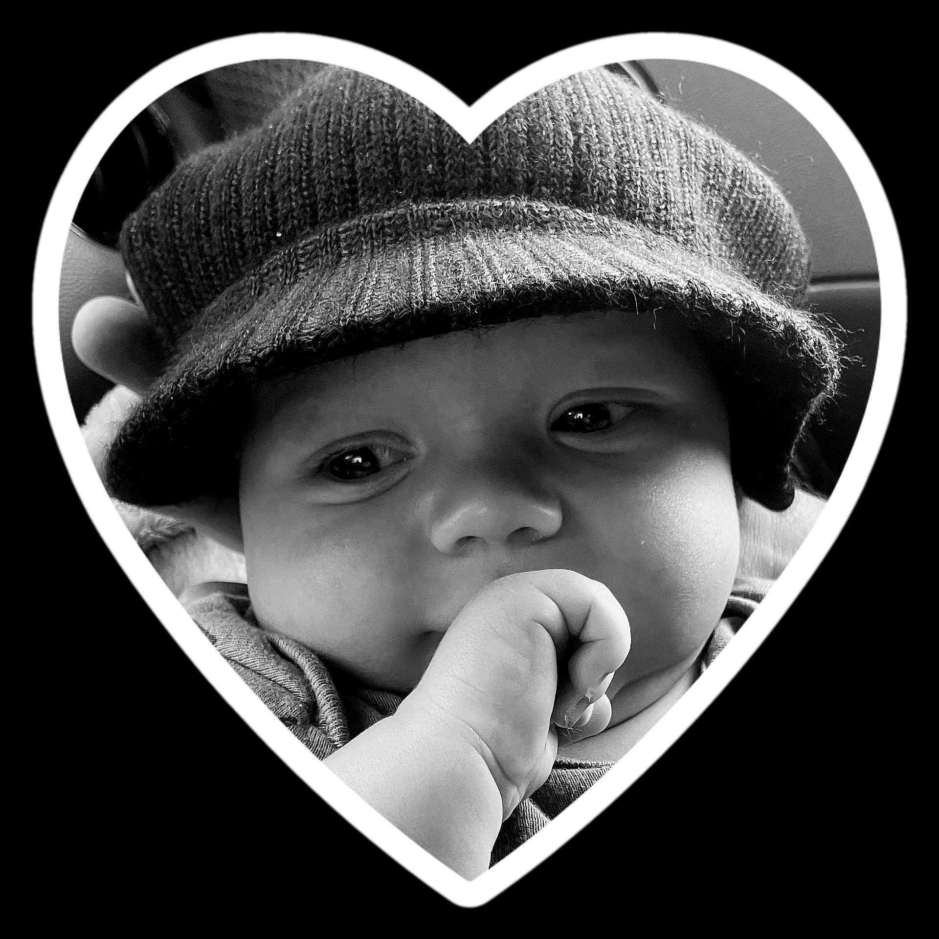 Jericho is registered to the contest to win money with this photo: baby, beanie, bodypart, bonnet, cap, clothing, coat, face, finger, hand, hat, head, heart, hood, jacket, knitwear, person, photography, portrait, sweater