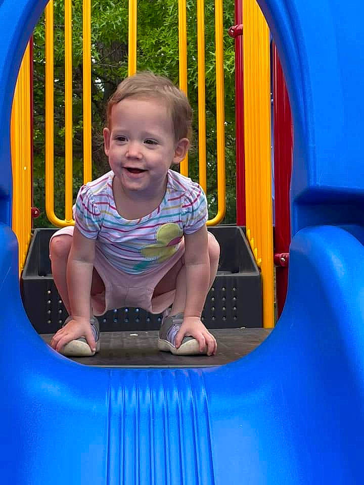 Jasmin is registered to the contest to win money with this photo: automotive_exterior, baby_toddler_clothing, blue, child, chute, city, fun, green, hood, joy, leisure, light, outdoor_play_equipment, person, photograph, playground, recreation, red, smile, toddler