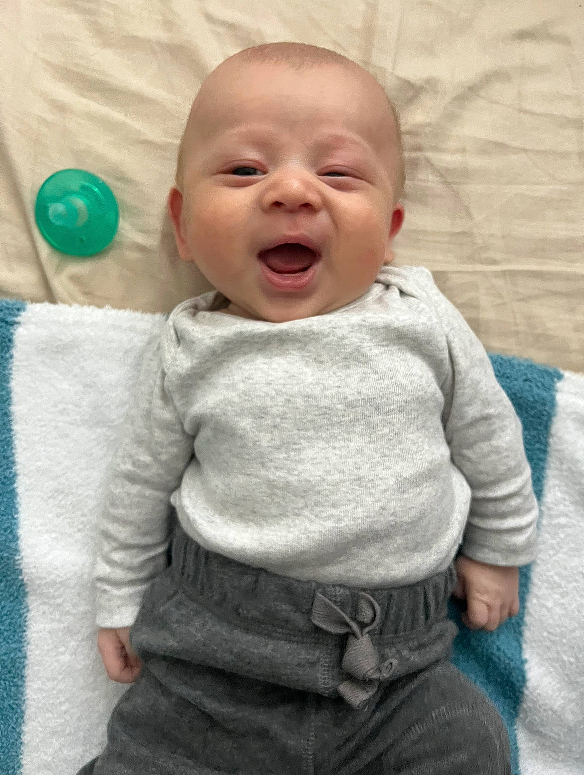 Castiel is registered to the contest to win money with this photo: baby, baby_laughing, baby_toddler_clothing, cheek, child, comfort, eye, face, happy, head, human_body, laugh, linens, nose, pattern, person, skin, sleeve, smile, t_shirt