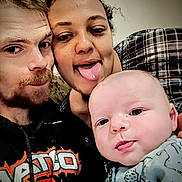 Lucus is registered to the contest to win money with this photo: man, woman, baby, face, tongue, smile, playful, selfie, closeup, expression, casual, indoor, people, portrait, clothing, hoodie, plaid, curly_hair, light_skin, happy