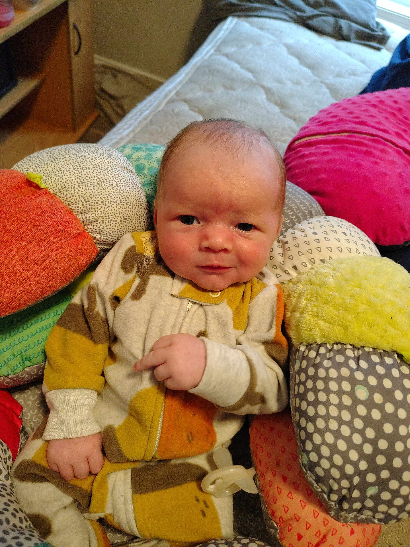 Lucus joined the competition — help win amazing prizes! baby, infant, child, onesie, cushion, pillow, bed, blanket, indoor, face, hand, expression, soft_toys, patterned_clothing, newborn, person, comfort, cozy, cute, smile