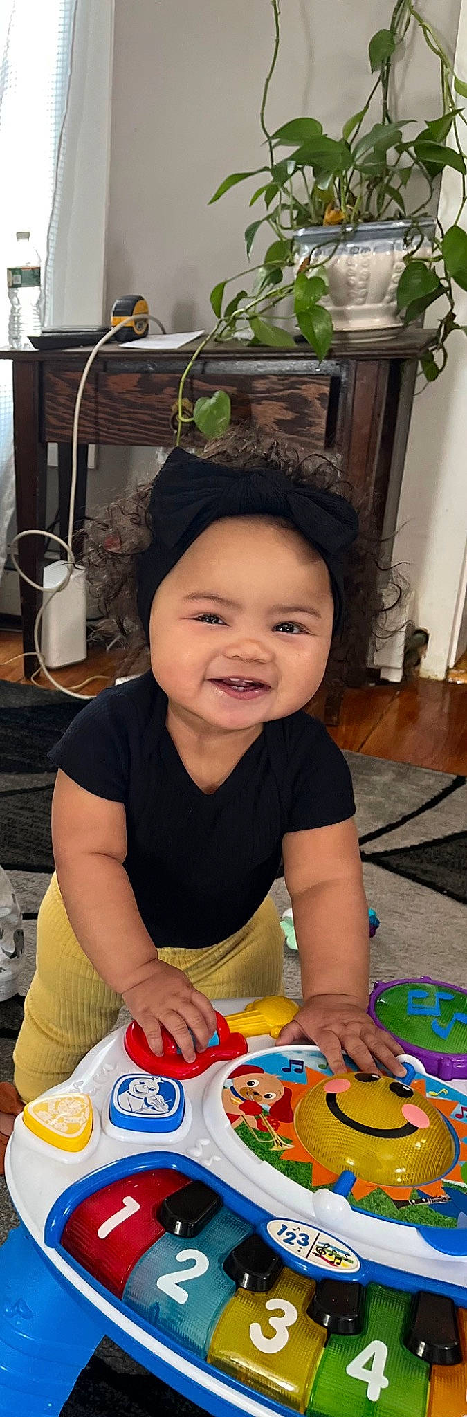 Avianna is registered to the contest to win money with this photo: baby, baby_playing_with_toys, chair, cheek, child, flooring, fun, happy, headwear, houseplant, joy, lamp, leisure, party, person, room, sitting, smile, toddler, vacation