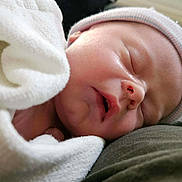 Jaxon is registered to the contest to win money with this photo: newborn, baby, sleeping, blanket, cap, closeup, face, infant, peaceful, resting, soft, wrapped, cute, skin, headwear, indoors, portrait, cozy, child, sleep