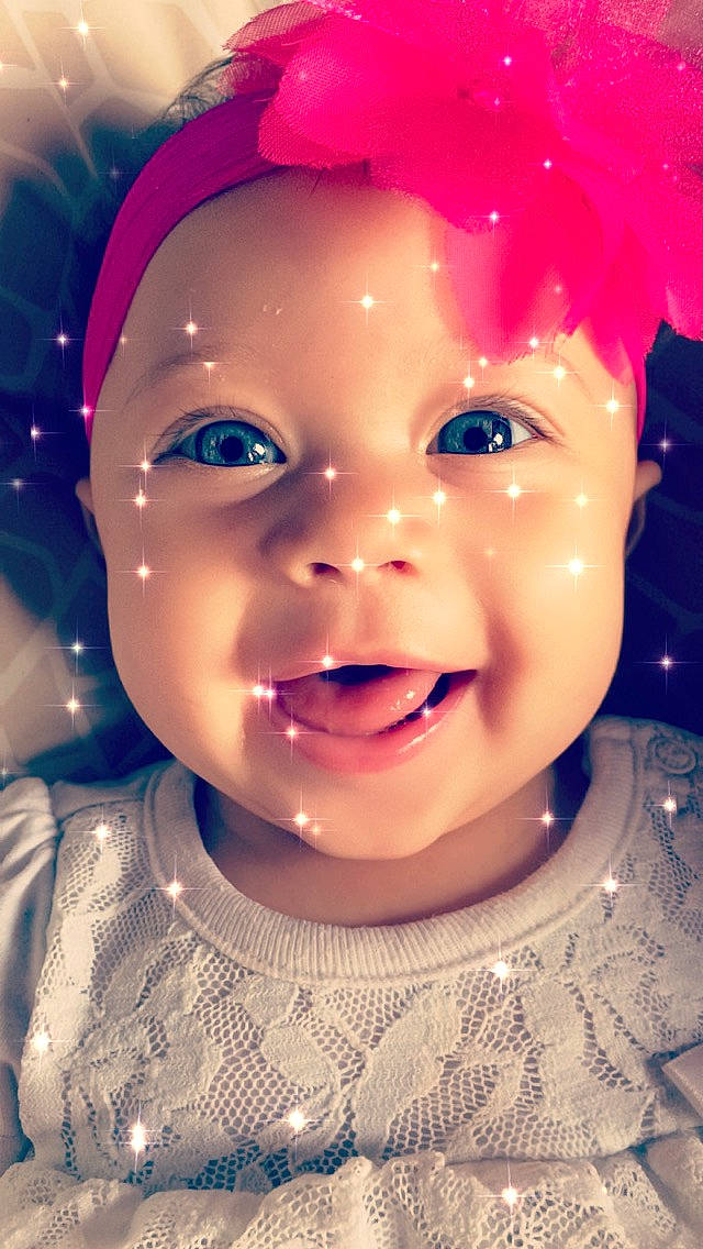 Quinn is registered to the contest to win money with this photo: baby, beauty, cheek, child, chin, close_up, eye, eyebrow, face, facial_expression, forehead, fun, head, lip, nose, organ, person, pink, skin, smile