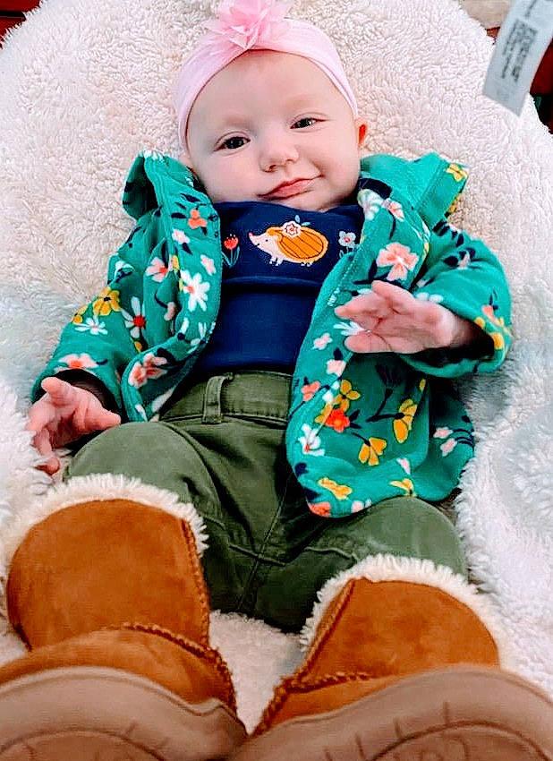 Kenley joined the competition — help win amazing prizes! baby, baby_toddler_clothing, cheek, comfort, dress, eye, green, happy, head, headgear, headwear, human_body, jacket, outerwear, person, pink, skin, sleeve, smile, textile