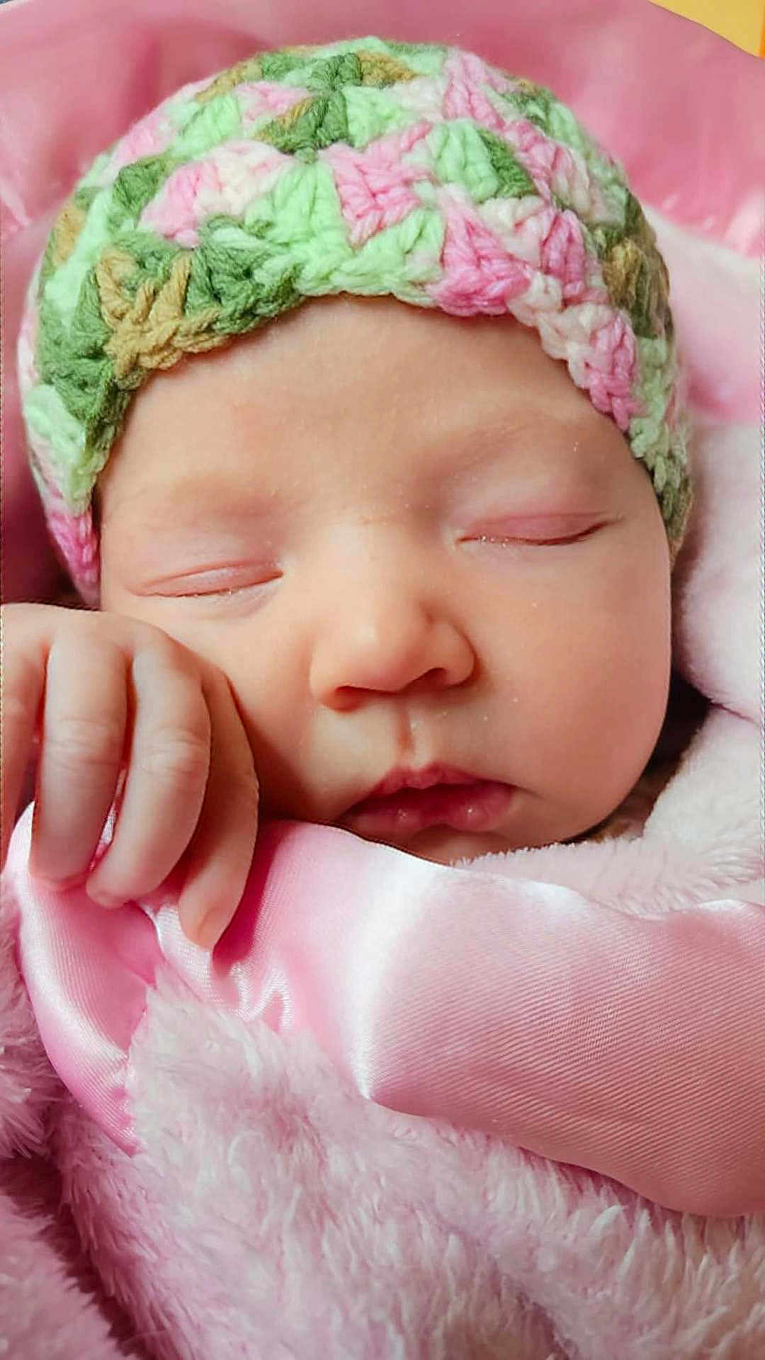 Elizabeth joined the competition — help win amazing prizes! baby, newborn, sleeping, face, hand, blanket, pink, crocheted_hat, soft_texture, closeup, infant, peaceful, cute, cozy, portrait, wrapped, child, sleep, rest, warm