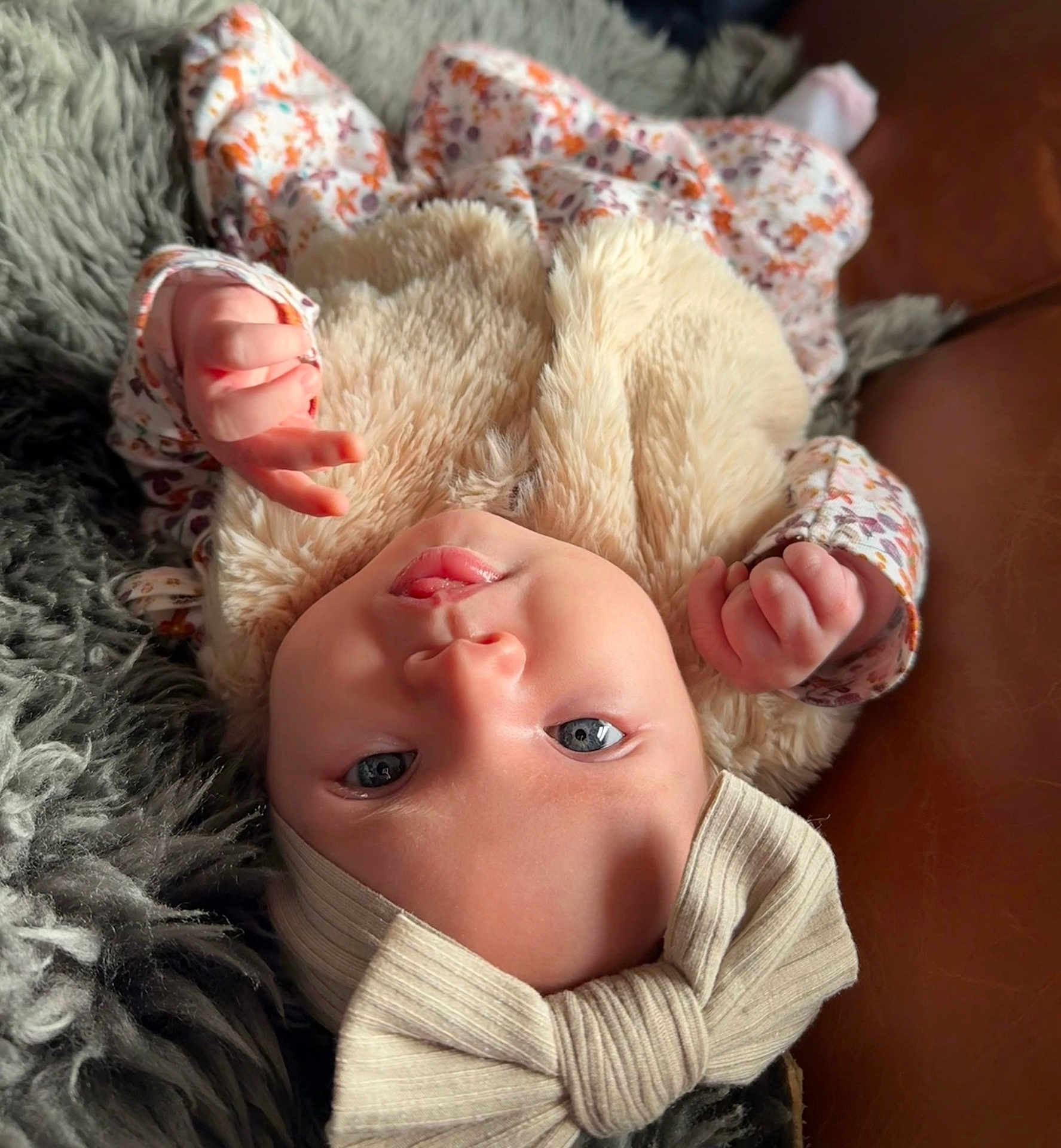 Gabby joined the competition — help win amazing prizes! baby, infant, face, headband, bow, clothing, fur, floral_pattern, hand, skin, eyes, mouth, lying_down, blanket, texture, soft, cute, portrait, child, indoor
