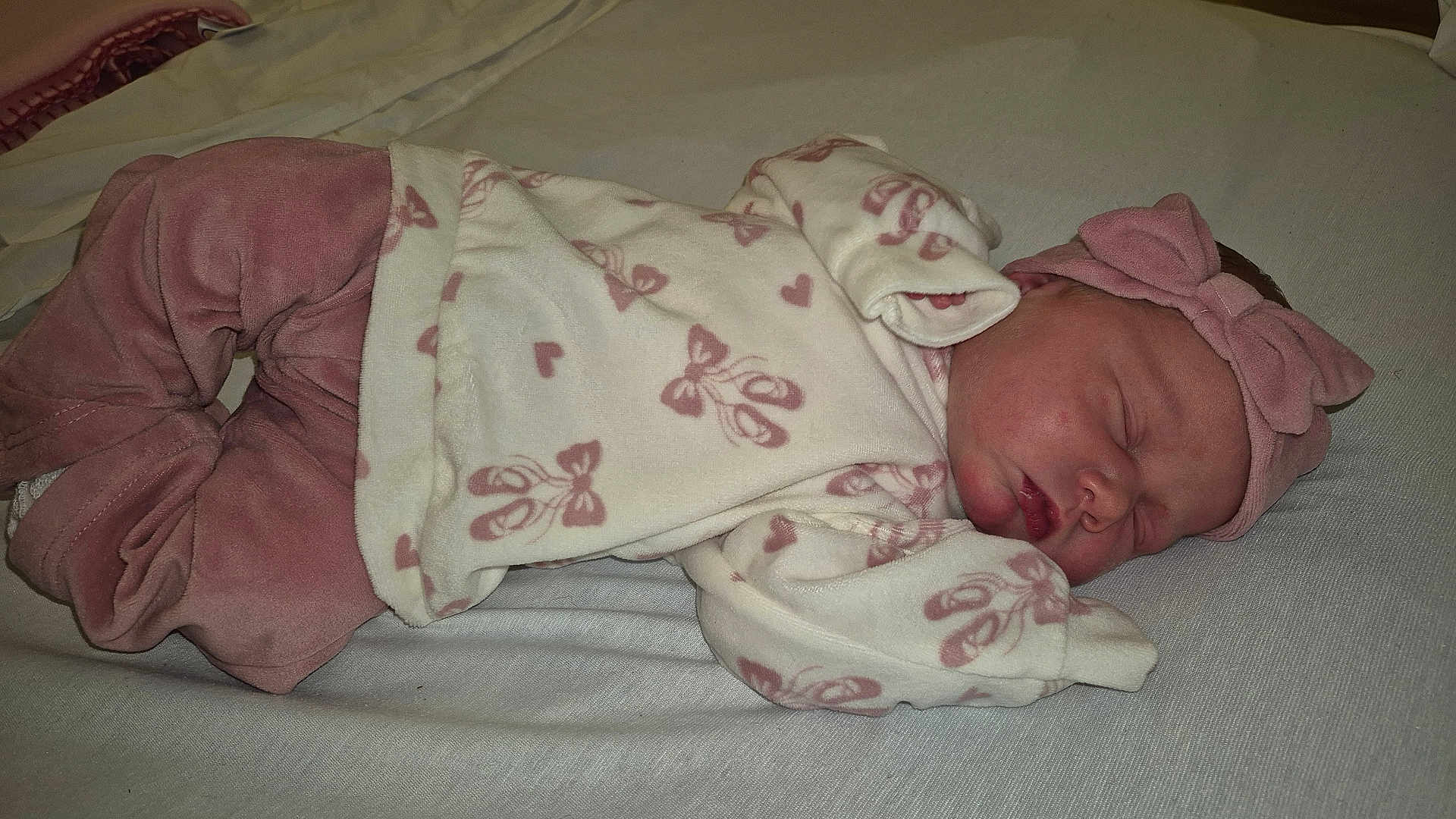 Emma-Leigh joined the competition — help win amazing prizes! baby, newborn, sleeping, pink_clothing, headband, bow, infant, soft_fabric, bed, blanket, peaceful, child, cute, resting, sleep, portrait, indoors, cozy, small, human