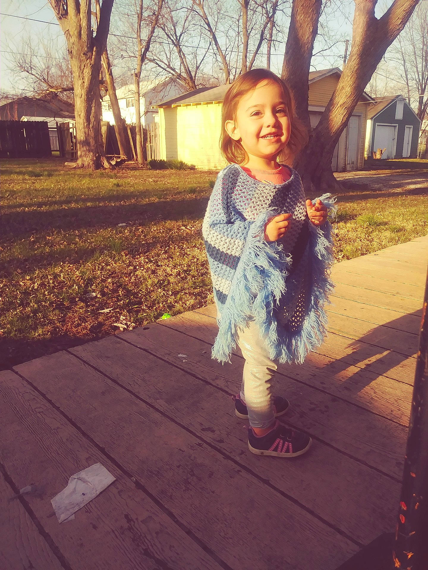 Liliana is registered to the contest to win money with this photo: child, clothing, cool, day, emotion, facial_expression, fun, girl, happiness, joy, leg, person, photograph, recreation, smile, snapshot, standing, sunlight, toddler, tree