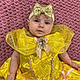Brinley is registered to the contest to win money with this photo: baby, big_eyes, brooch, chubby_cheeks, closeup, costume, cute, fabric_texture, gold_bow, hand, headband, infant, lying_down, pink_blanket, portrait, princess_dress, ruffle, satin, smile, yellow_dress