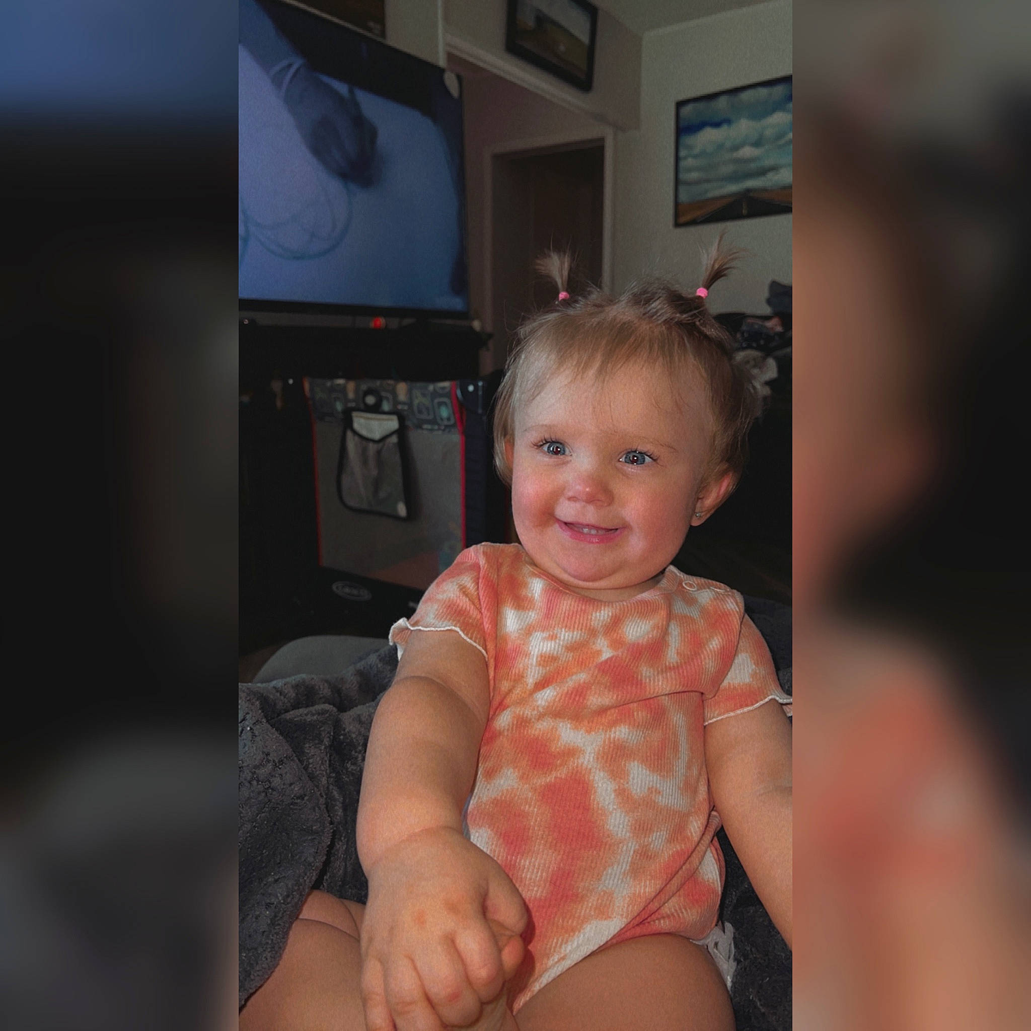 Madison is registered to the contest to win money with this photo: baby, baby_toddler_clothing, comfort, elbow, flash_photography, fun, gadget, happy, home_appliance, human_leg, joy, knee, person, shorts, skin, sleeve, smile, television, television_set, thigh