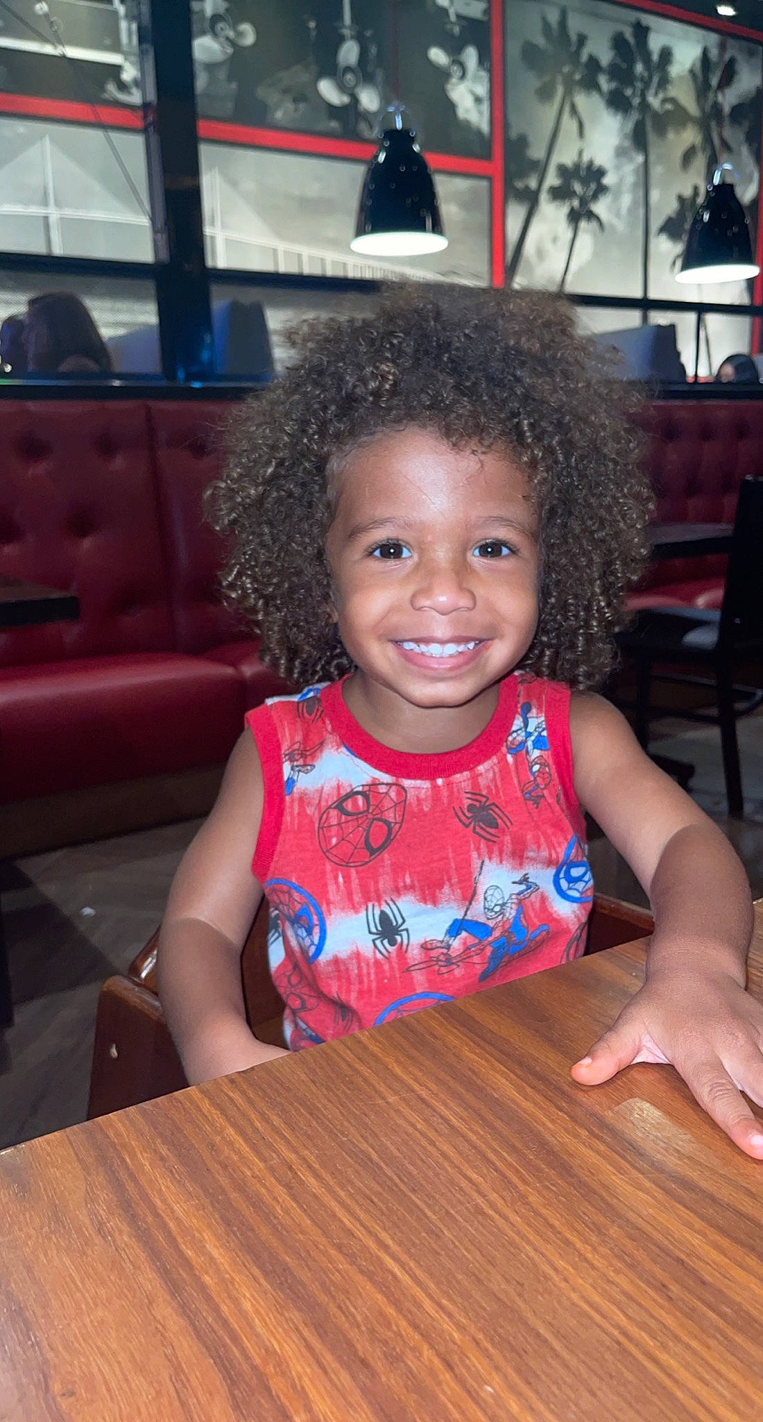 Cyprus is registered to the contest to win money with this photo: chair, child, chin, event, flooring, fun, furniture, happy, hardwood, iris, joy, leisure, person, skin, smile, t_shirt, table, tableware, toddler, varnish