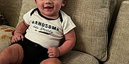 Aziel joined the competition — help win amazing prizes! baby, black_shorts, casual_clothing, child, comfortable, couch, cute, furniture, happy, home, indoors, person, plush, portrait, shoe, sitting, smiling, sneaker, white_shirt, young_child