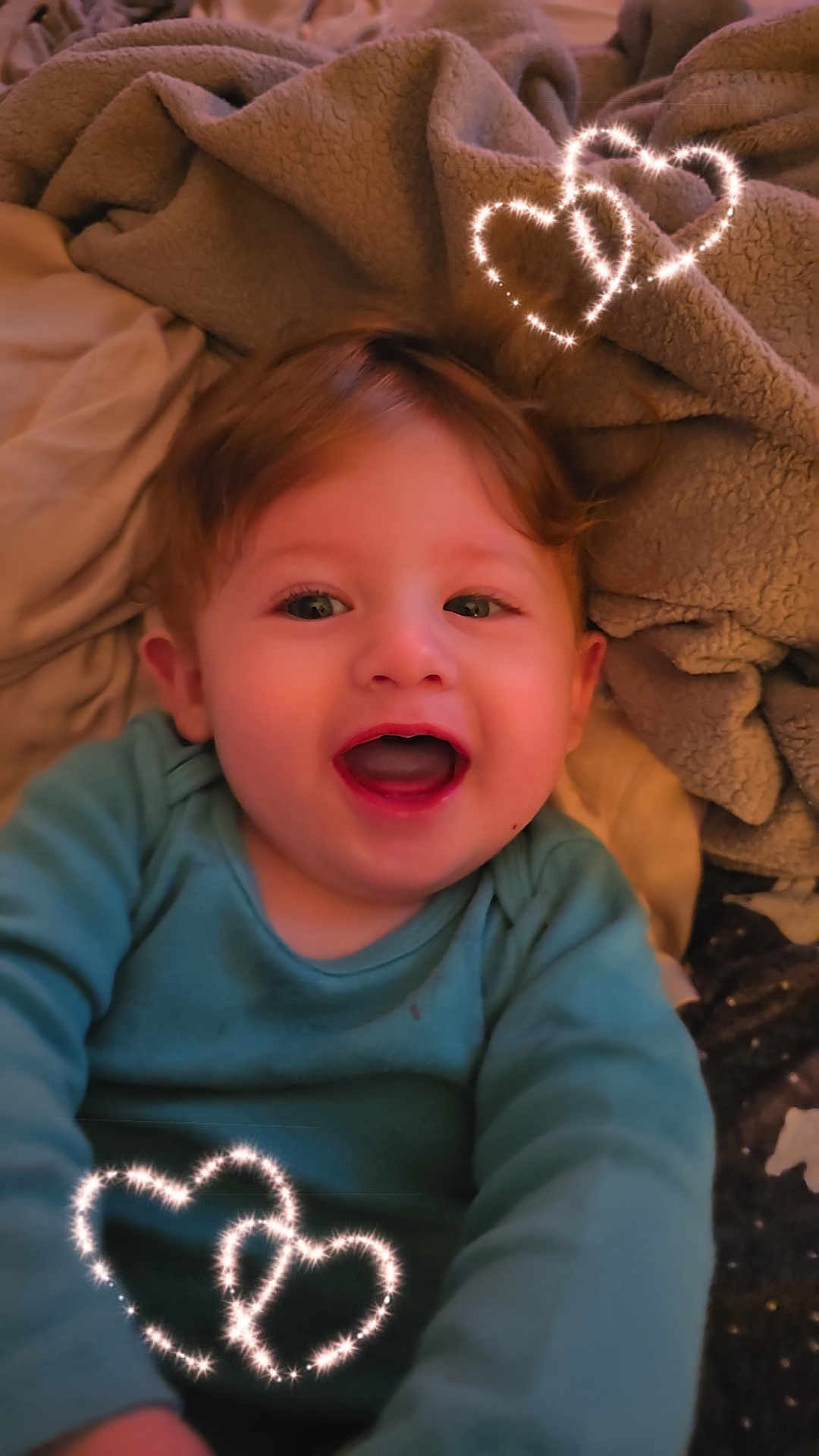 Sage is registered to the contest to win money with this photo: baby, child, smiling, happy, face, blanket, cozy, heart, doodle, sparkle, cute, infant, clothing, portrait, indoors, warm, expression, joy, toddler, soft