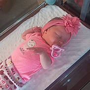 Rosemary joined the competition — help win amazing prizes! newborn, baby, sleeping, pink_clothing, headband, pacifier, blanket, crib, infant, cute, peaceful, indoors, child, toddler, soft, resting, human, small, adorable, portrait