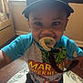 toddler, child, pacifier, marvel, superhero, shirt, cap, nike, smiling, indoors, rug, animal_print, floor, wooden_floor, window, baby, cute, happy, person, clothing