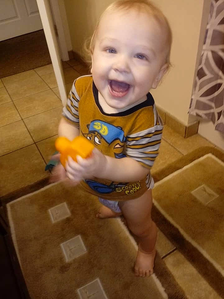 Kolten is registered to the contest to win money with this photo: baby, child, facial_expression, floor, flooring, leg, mouth, person, play, room, skin, smile, toddler