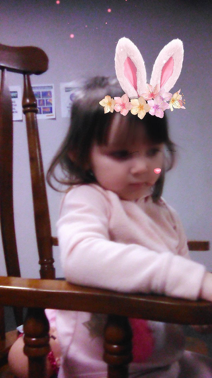 Annabel is registered to the contest to win money with this photo: baby, baby_toddler_clothing, bangs, beauty, child, child_model, costume_accessory, embellishment, fashion_accessory, hair_accessory, headband, headgear, headpiece, insect, lamp, person, pink, pollinator, product, sconce