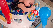 Nevaeh is registered to the contest to win money with this photo: baby, infant, sleeping, child, activity_center, baby_toy, playmat, colorful, indoor, home, tile_floor, seated, hugging, toy, playtime, blue_ball, plastic, portrait, resting, cute