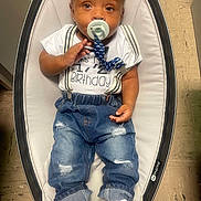 Delijah joined the competition — help win amazing prizes! baby, infant, pacifier, jeans, white_shoes, baby_rocker, half_birthday, clothing, sitting, indoor, floor, cute, child, fashion, white_shirt, denim, suspenders, footwear, baby_accessory, portrait