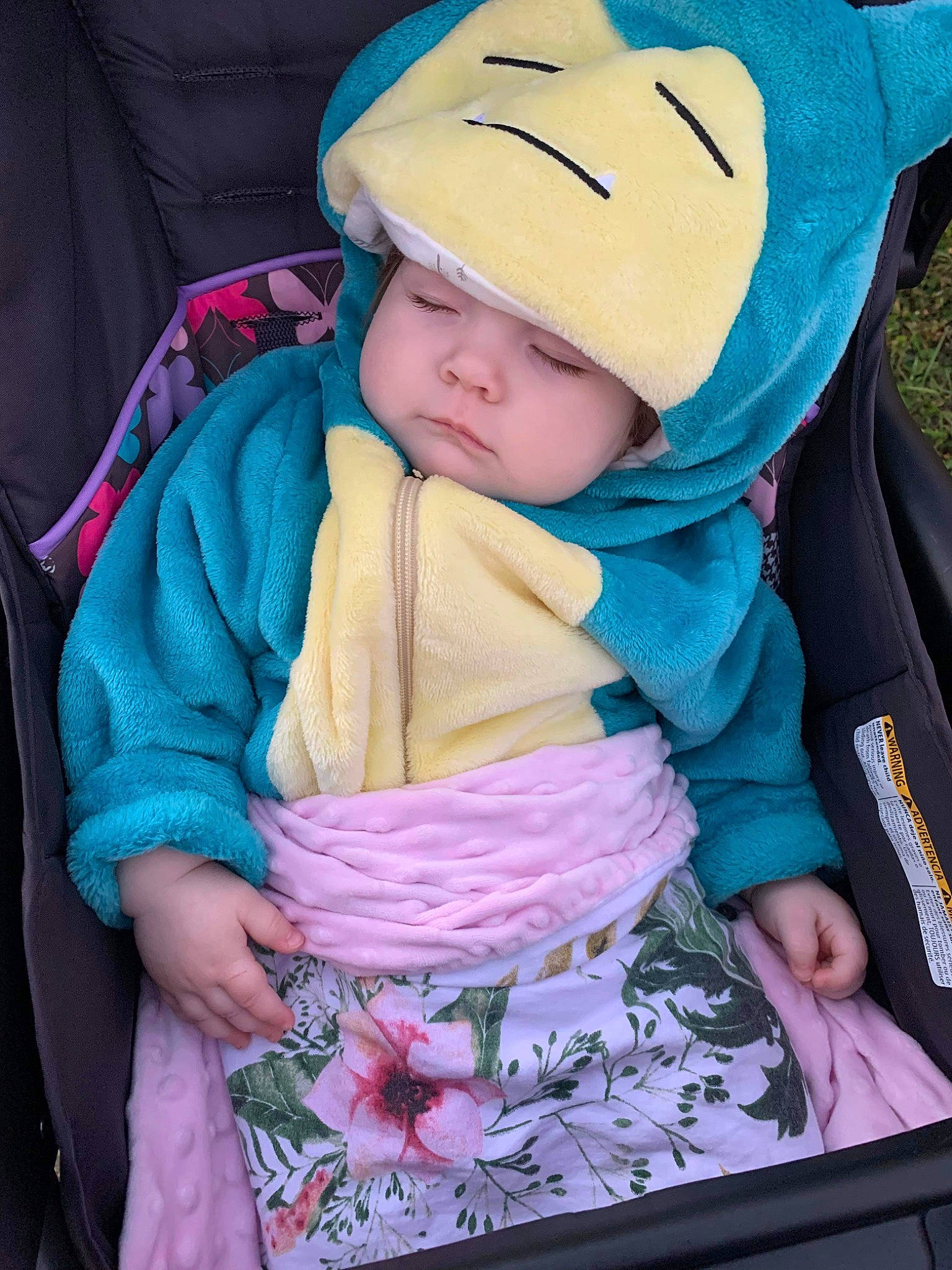 Naomi is registered to the contest to win money with this photo: baby, baby_carriage, baby_products, baby_safety, baby_toddler_clothing, beanie, cap, car_seat, cheek, child, comfort, electric_blue, fashion_accessory, happy, headwear, magenta, person, pink, product, sitting