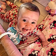 Hannah joined the competition — help win amazing prizes! baby, smiling, tongue_out, strawberry_pattern, onesie, blanket, minnie_mouse, toy, bottle, soft_toy, infant, cute, lying_down, playpen, happy, child, indoors, colorful, face, closeup