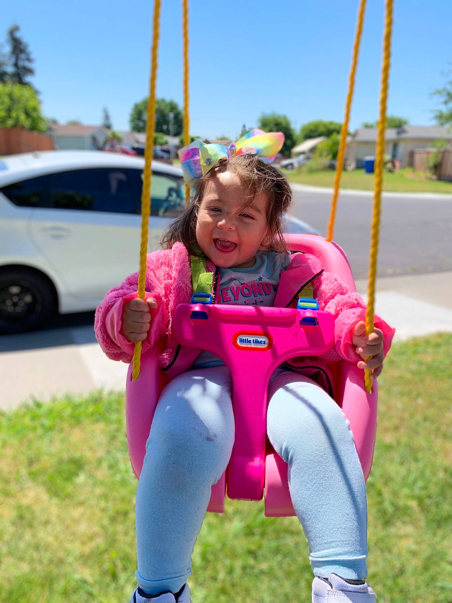 Anabella is registered to the contest to win money with this photo: child, fun, leisure, outdoor_play_equipment, person, pink, plant, play, playground, public_space, recreation, smile, swing, toddler, tree, vacation