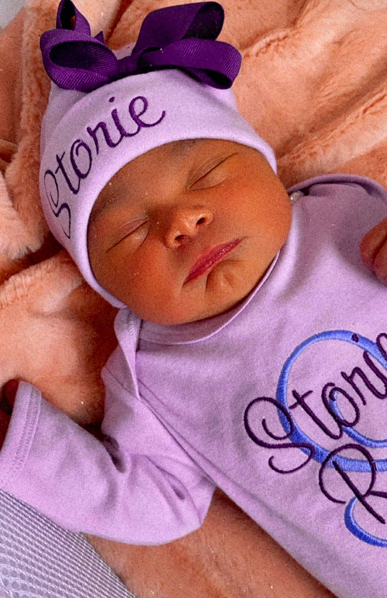 Storie is registered to the contest to win money with this photo: baby, baby_products, baby_sleeping, baby_toddler_clothing, bedtime, cap, cheek, comfort, eyebrow, happy, headwear, linens, magenta, nap, nose, person, pink, purple, sleeve, textile
