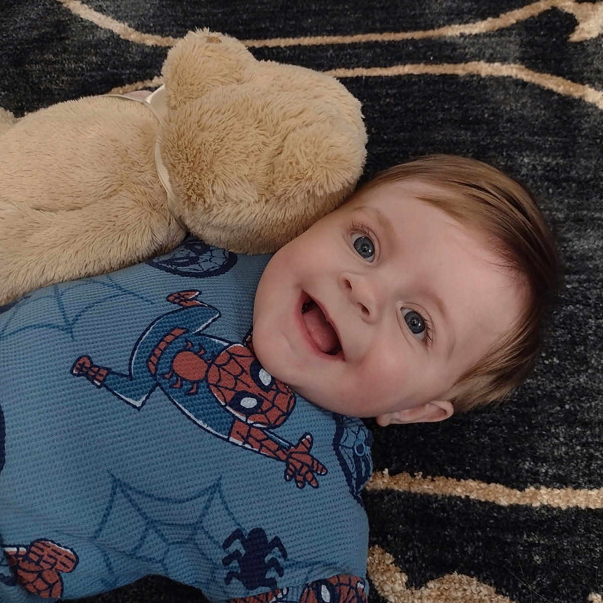 Riley joined the competition — help win amazing prizes! baby, blanket, bodypart, clothing, couch, cushion, face, happy, head, homedecor, laughing, mouth, person, photography, portrait, quilt, smile, t_shirt, teeth, toy