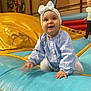 Charlize participe au concours pour gagner de l'argent avec cette photo : toddler, child, inflatable, playground, indoor, blue, yellow, red, headband, bow, clothing, happy, smiling, play, fun, kid, person, mural, background, activity