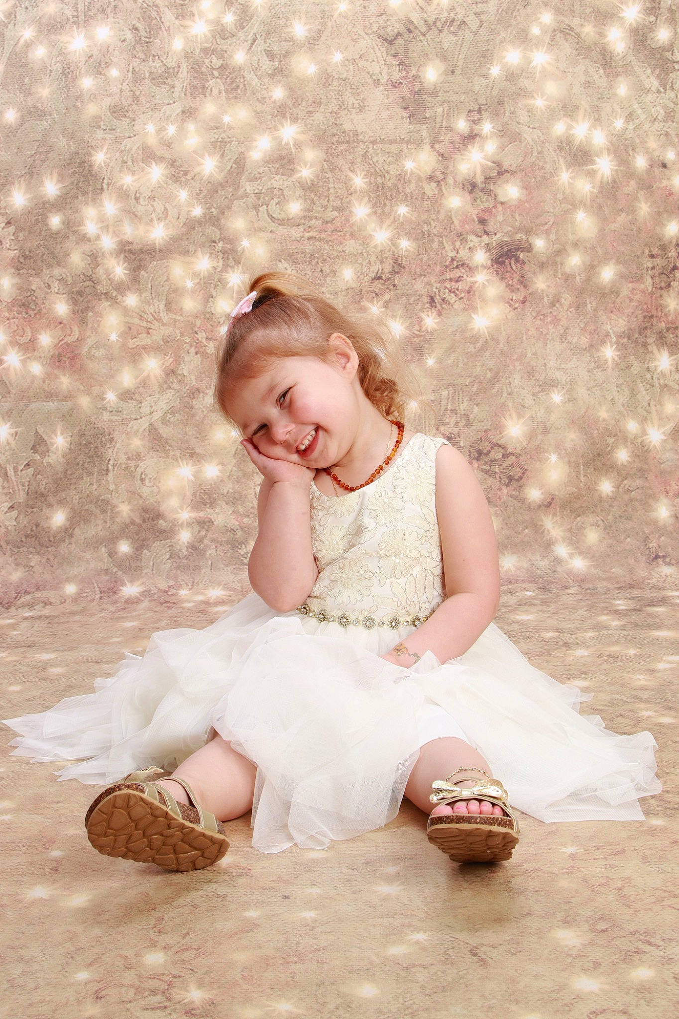 Evie is registered to the contest to win money with this photo: barefoot, blond, bridal_accessory, child, dress, embellishment, event, facial_expression, fashion_accessory, flash_photography, footwear, fun, grass, hairstyle, happy, joy, people_in_nature, person, sitting, skin