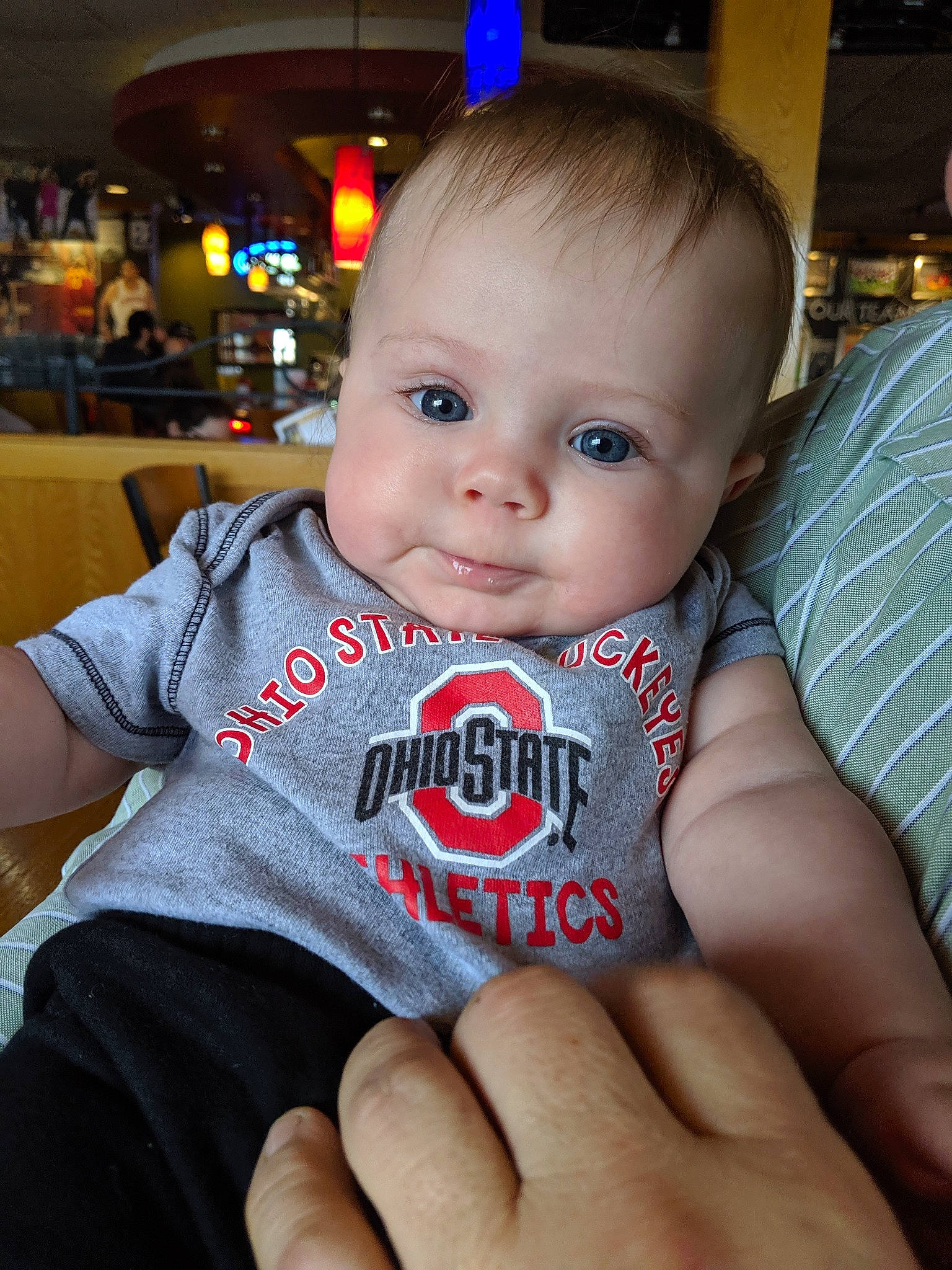 Quinn is registered to the contest to win money with this photo: baby, cheek, child, chin, ear, eye, face, finger, hand, head, iris, lip, mouth, nose, person, sitting, skin, smile, thumb, toddler