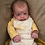 baby, infant, child, face, person, clothing, yellow_sweater, winnie_the_pooh, blanket, couch, seated, cute, soft_texture, indoors, young, portrait, small_hands, expression, cozy, comfort