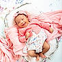 baby, infant, smiling, pink_clothing, headband, basket, blanket, floral_pattern, flower_background, cute, happy, lying_down, portrait, child, soft_texture, cozy, indoors, newborn, skin, foot