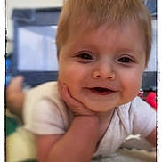Kayce is registered to the contest to win money with this photo: baby, smile, face, hand, closeup, infant, child, cute, portrait, skin, hair, eyes, mouth, resting, indoors, soft_focus, vintage_border, white_clothing, happy, young