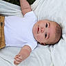 Enzo joined the competition — help win amazing prizes! baby, blanket, calm, child, clothing, curious, cute, face, grass, head, infant, lying_down, mustard_pants, outdoor, person, portrait, reaching_hand, skin, white_shirt, young
