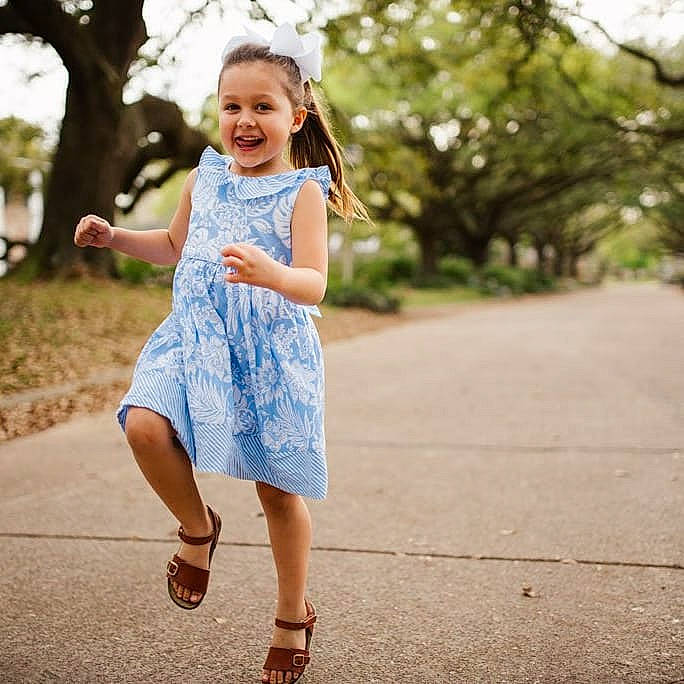 Avery is registered to the contest to win money with this photo: day_dress, denim, dress, electric_blue, eye, flash_photography, footwear, grass, hair, happy, joy, knee, long_hair, people_in_nature, person, plant, shoulder, sleeve, smile, toddler
