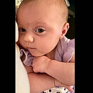Koraline is registered to the contest to win money with this photo: baby, infant, child, face, portrait, purple_clothing, cute, expression, closeup, skin, arm, hand, indoor, soft_light, young, person, looking, curious, holding, cartoon_print