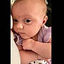 baby, infant, child, face, portrait, purple_clothing, cute, expression, closeup, skin, arm, hand, indoor, soft_light, young, person, looking, curious, holding, cartoon_print