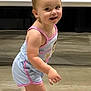 toddler, child, smile, walking, sandals, romper, indoor, floor, metal, aircraft, vehicle, hair, cute, happy, person, skin, footwear, pose, baby, infant