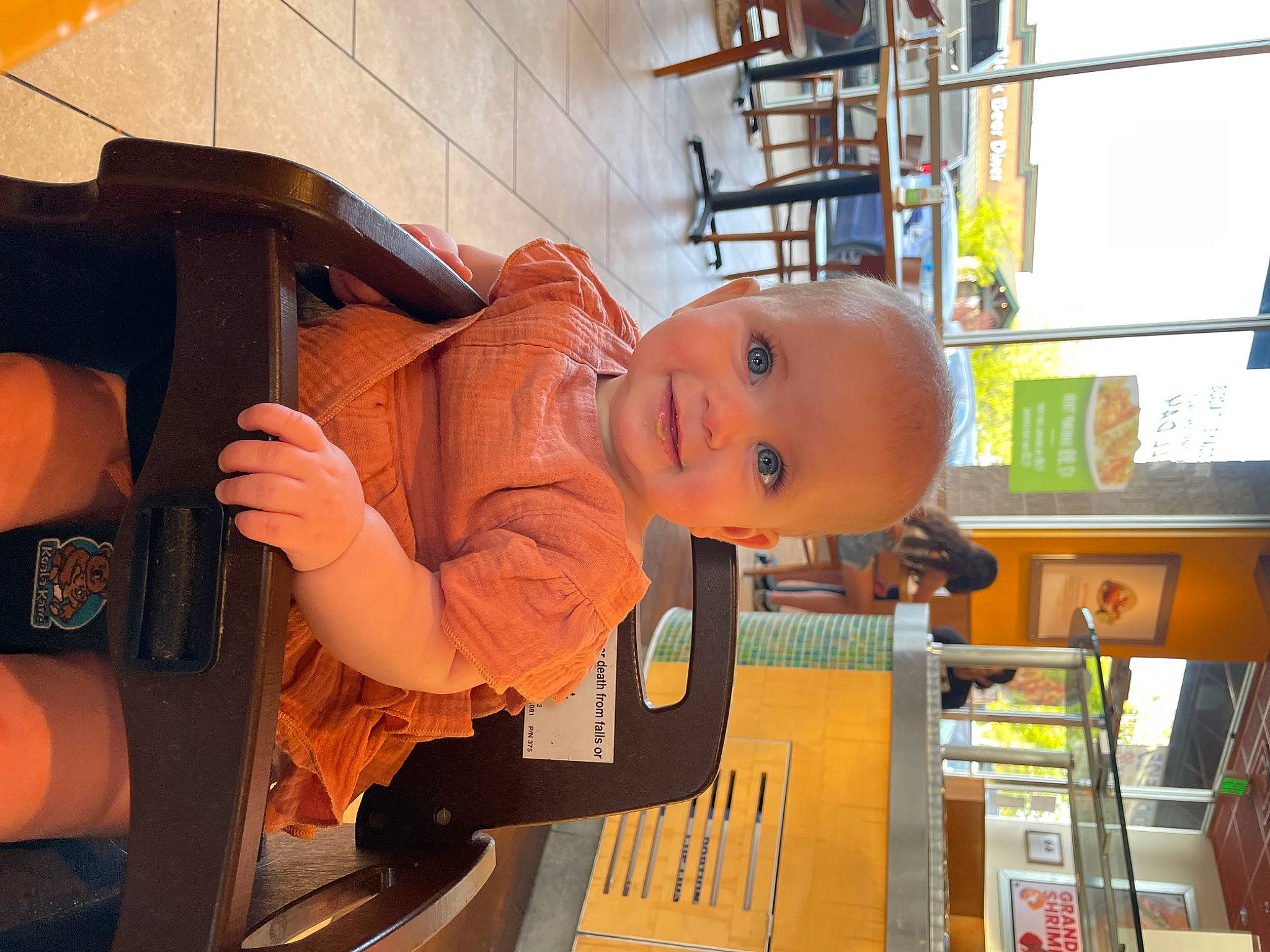 Anna is registered to the contest to win money with this photo: automotive_exterior, baby, baby_products, baby_safety, baby_toddler_clothing, child, fun, hat, house, joy, orange, person, personal_protective_equipment, room, shelf, shelving, smile, tire, toddler, tree